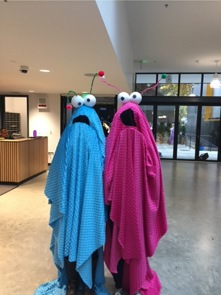 A couple of people dressed in clothing Description automatically generated